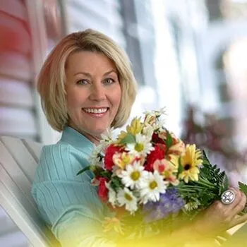 Woman holding flowers smiling