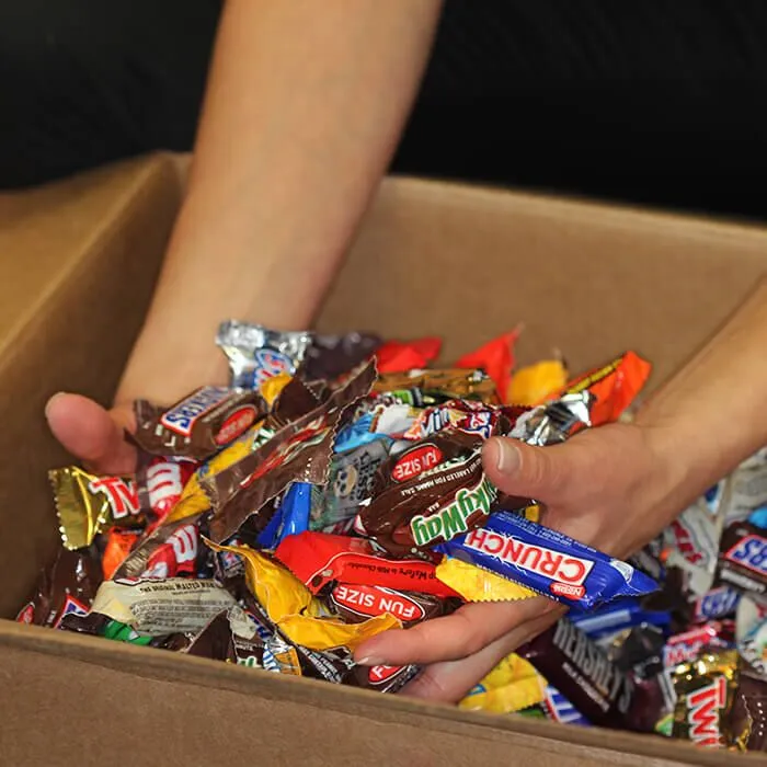 Hands holding candy in a box