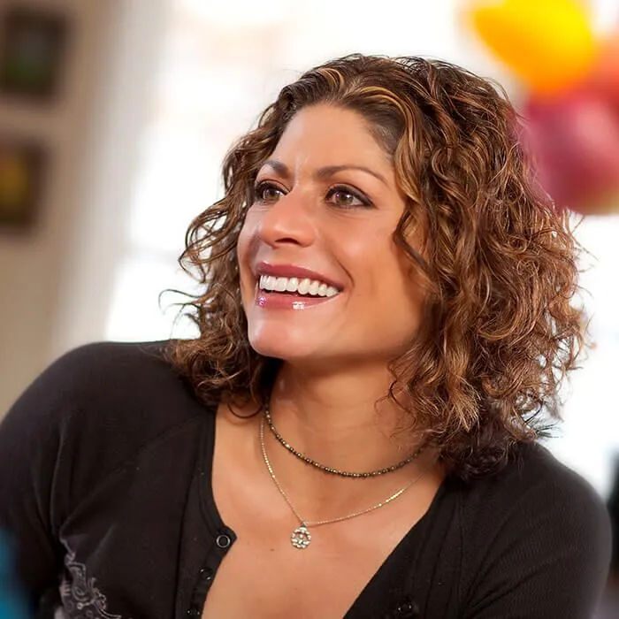 Curly haired woman smiling