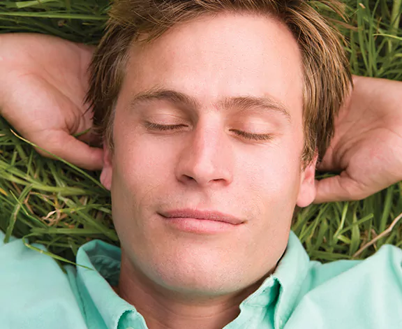 man laying in grass