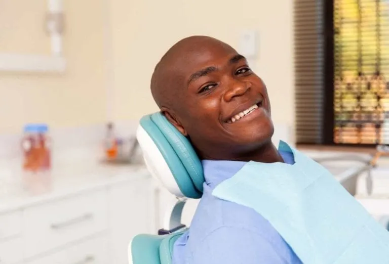 Smiling man seated in a dental chair