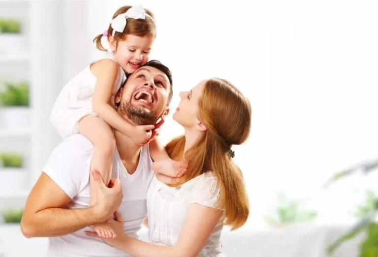 Smiling family with father, mother, and young daughter