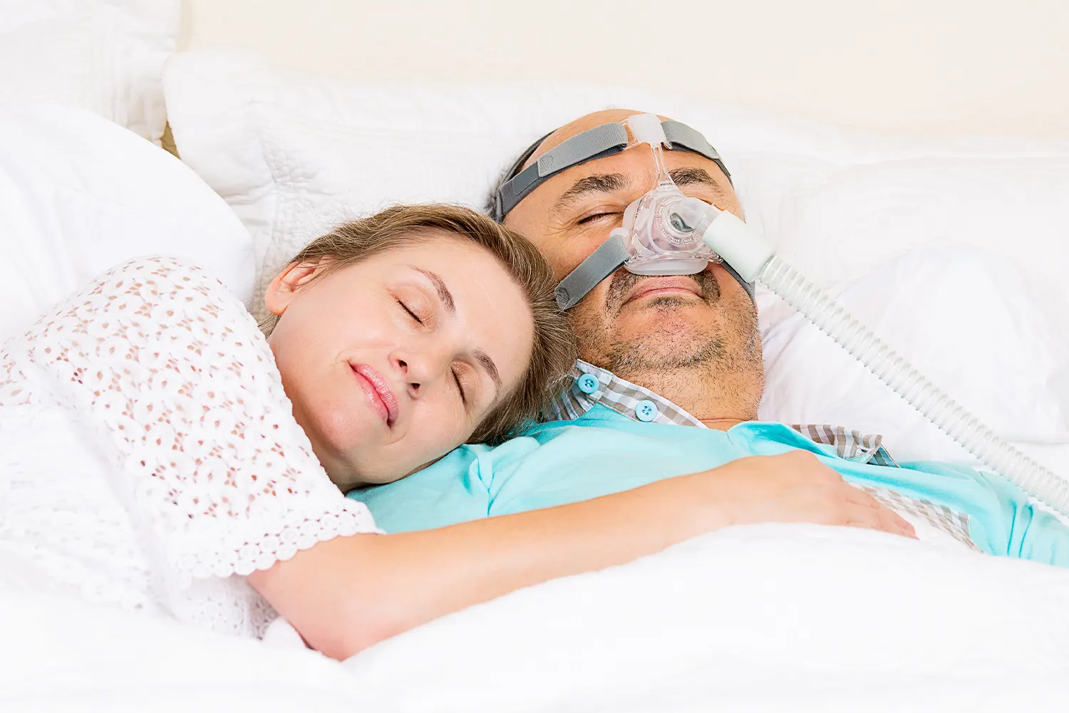 couple sleeping with sleep apnea machine