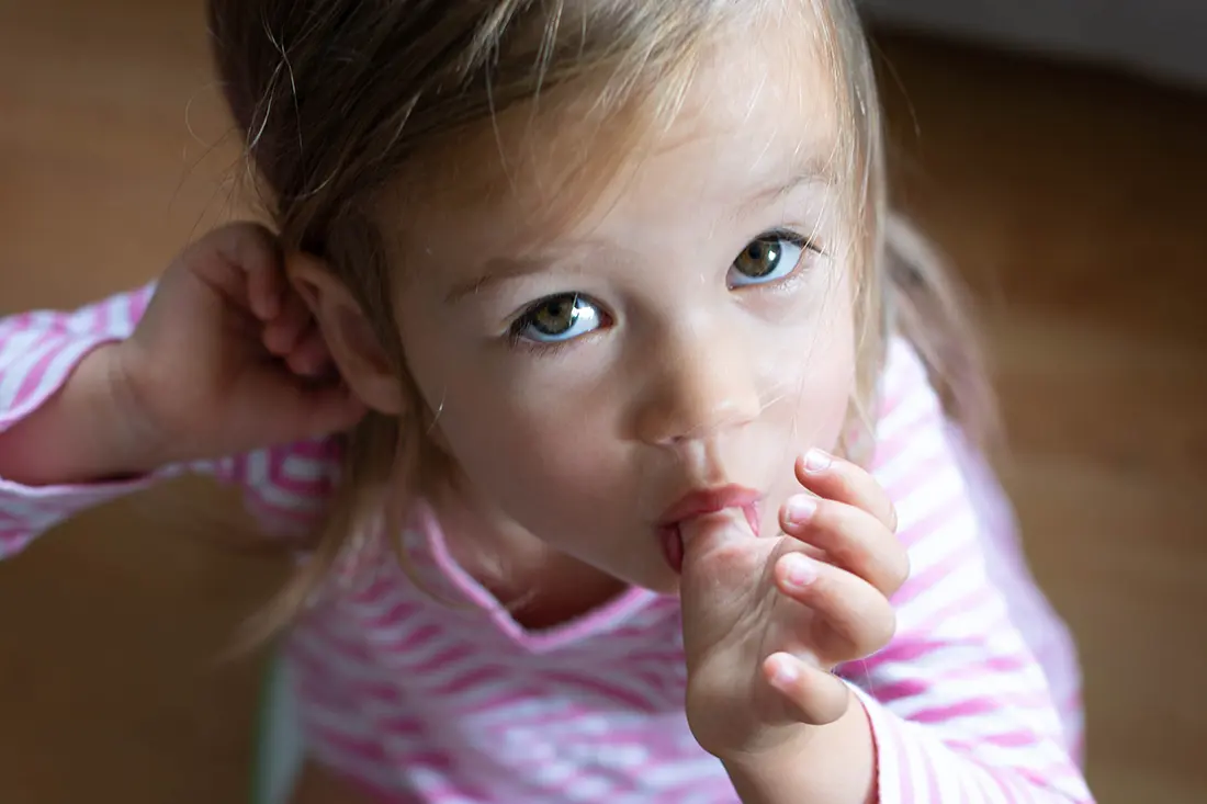 young girl sucking her thumb