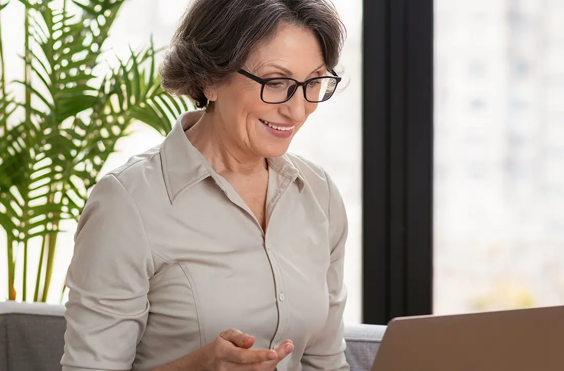 older woman with glasses smiling