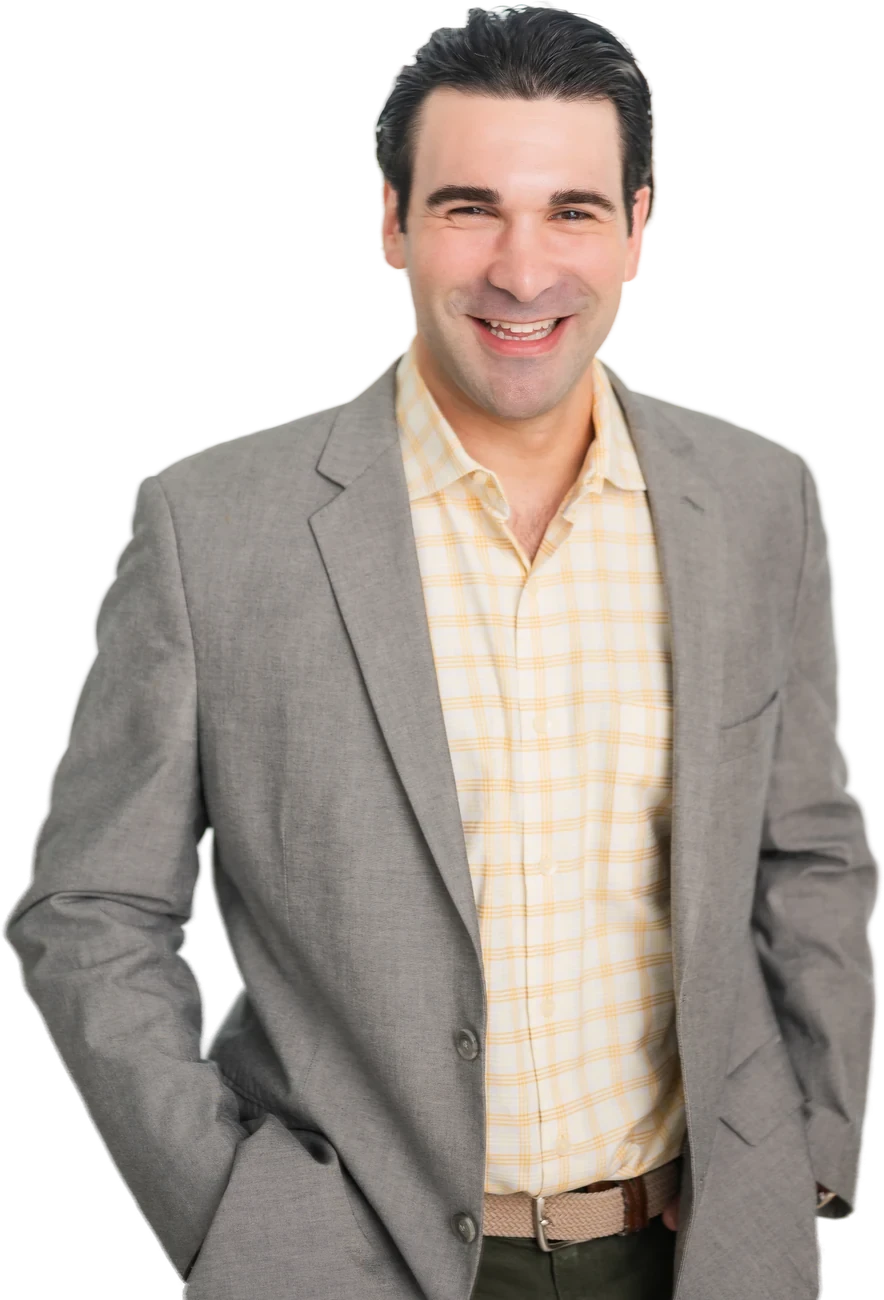 Dr. Kameron Tauber smiling with his hands in his pockets