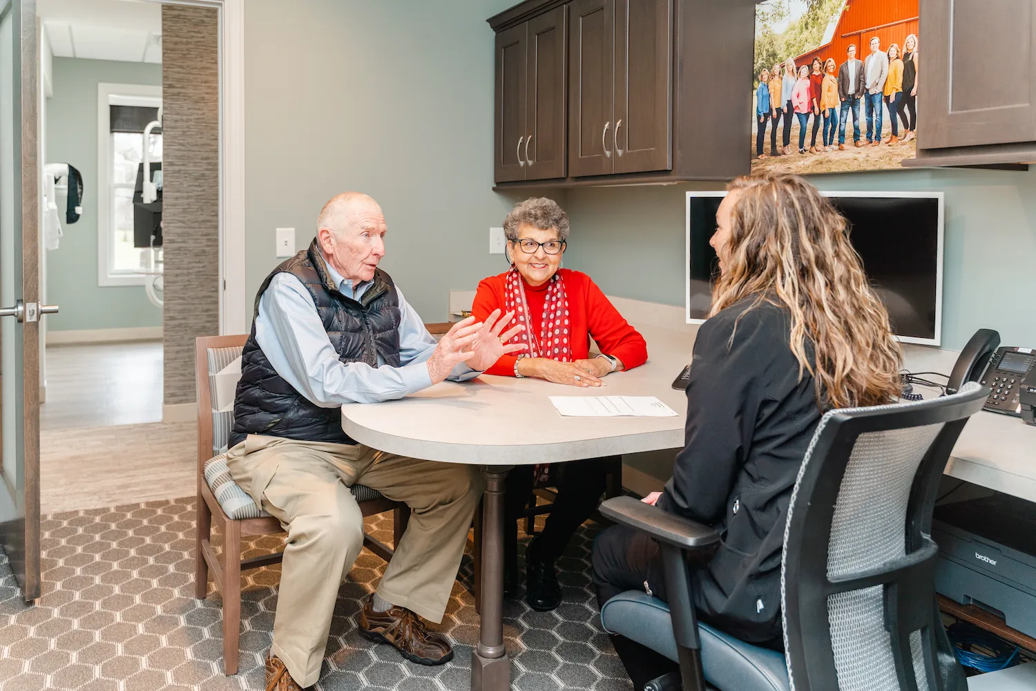 older couple meeting with team at East Brainerd Dentistry